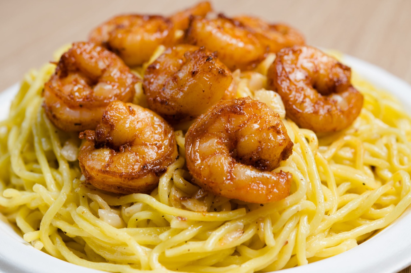 Garlic noodles topped with shrimp.